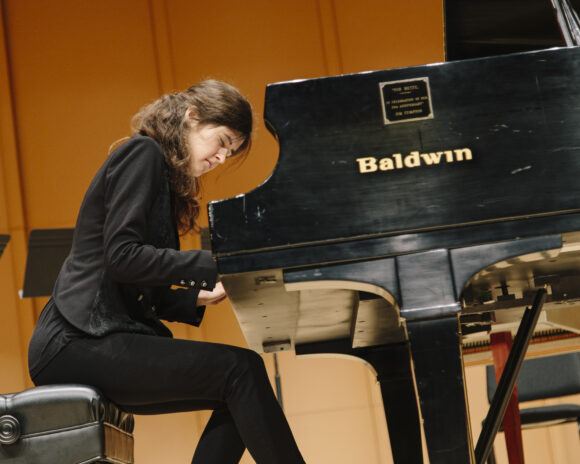 A pianist performs in at a concert.