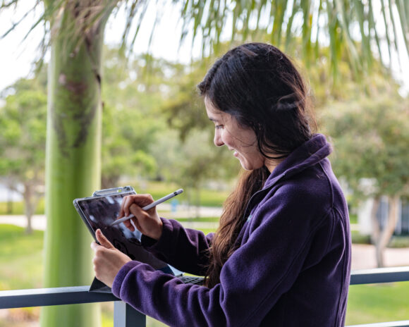 Lynn student studies outside with her iPad