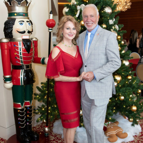 Kim Champion and Bruce Spizler pose next to a Nutcraker ornament.