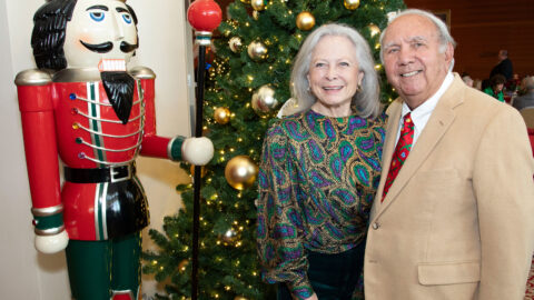 Deanna and Chris Wheeler pose in front of a Christmas tree and a Nutcracker ornament.