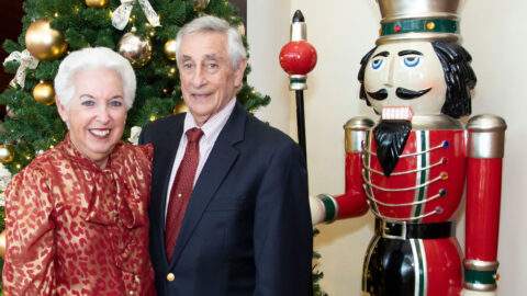 Barbie and Elliott Block pose in front of a Christmas tree and a Nutcracker ornament.