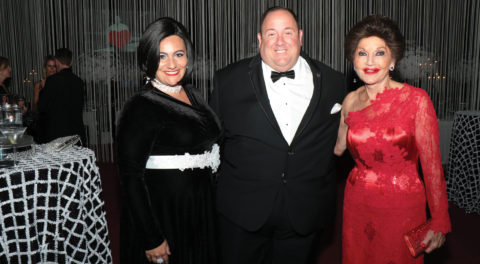 Maria Ana and Brian Siluquini, left and center, pose with Christine Lynn, right, at her 70th birthday party
