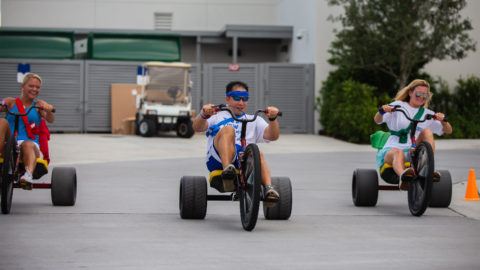 Students racing Big Wheels at Founders Day