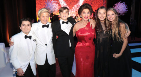 Christine Lynn posing with younger guests at 70th birthday