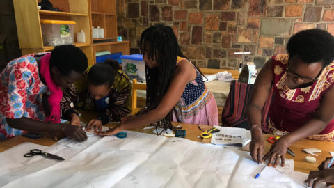Students help sew with community members in the Ambassador Corps program.