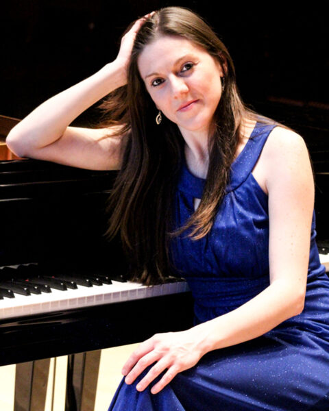 Natasha Stojanovska '11 poses in front of a piano.