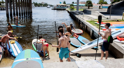 Students paddle boarding in Lake Boca