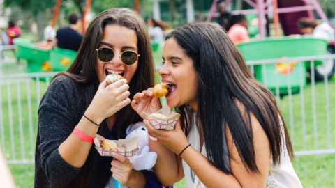 Two students eat goodies at Spring Fest