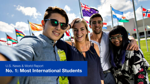 Students in front of flags with U.S. News No. 1 Most International Students text