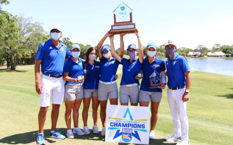 Women's golf team hold up their Sunshine State Conference trophy