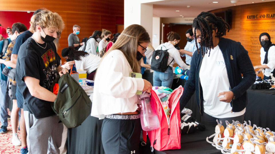 Students pack backpacks backpacks filled with comforting items for foster care children