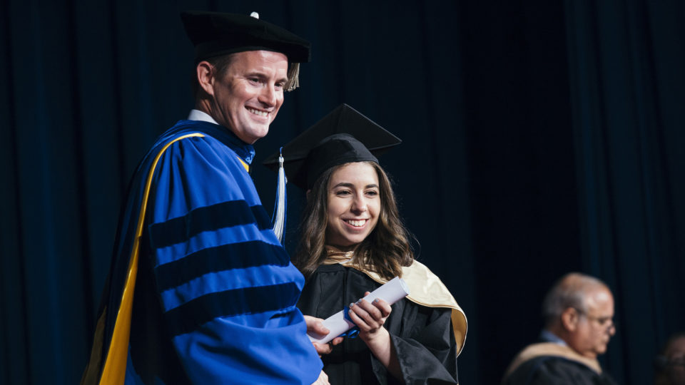 The first Lynn+ Watson graduate receives her degree.