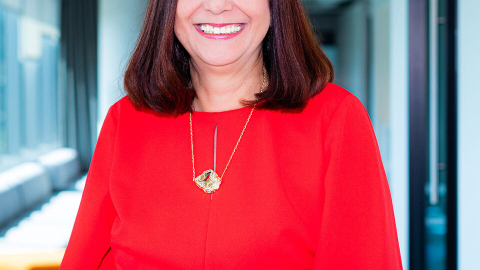 Mary Sol Gonzalez, co-founder of HEI, smiles wide for a headshot