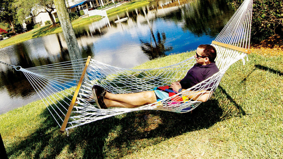 Student relaxing in hammock on Lynn campus