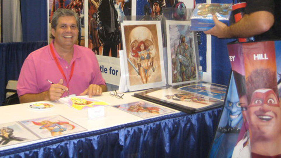 Artist-in-Residence Mark Sparacio sits a comic book convention with samples of his graphic novels