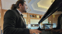 Dejan Daskalov '10 looking ahead as he plays the piano.