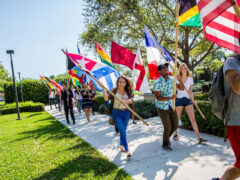 Students walking to park with flags