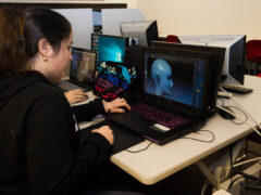 Student in the visual effects animation program works on the computer.