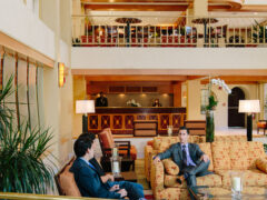 Two people talking in a resort lobby
