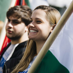 Students hold flags at Celebration of Nations.
