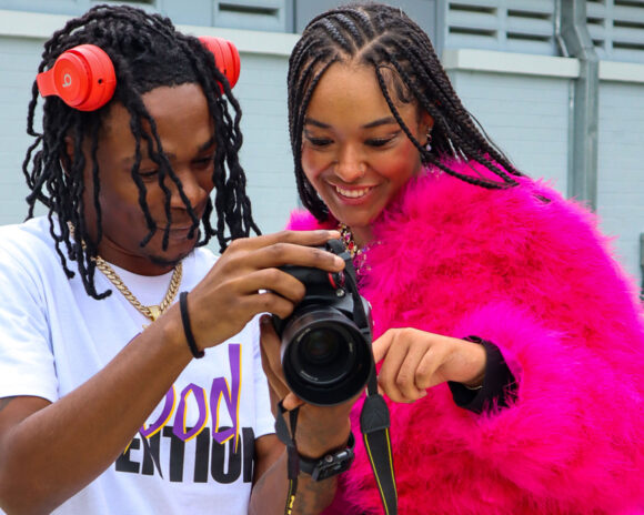 Photography student and fashion student preparing for fashion show.