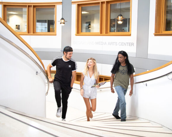 Students walking up the steps of the Design and Media Arts Center