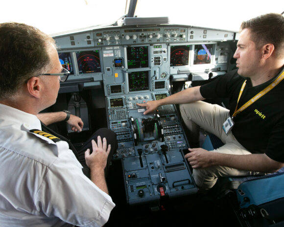 An instructor and a student in the cockpit together.