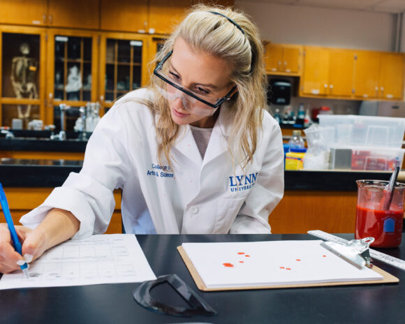 A student studies forensic evidence in a science lab.