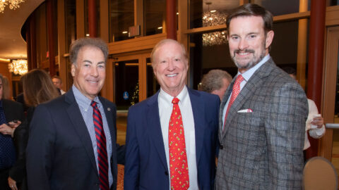 Greg Malfitano and Kevin M. Ross with an attendee at the 2023 President's Holiday Party
