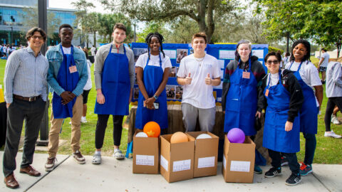 Students together in front of "Feeding South Florida" Citizenship Project at Citizenship Celebration event.