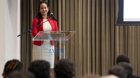 Katrina Cater-Tellison speaking to students in a podium during a C-Suite Speaker Event