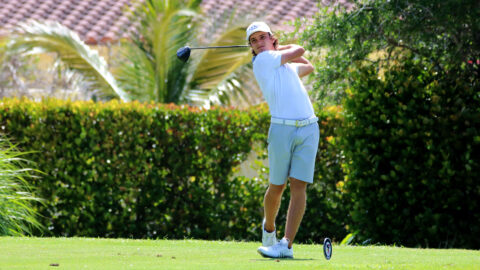 Men's golfer Carlos Bustos follows through on a swing