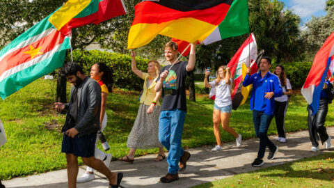 Students hoist their flags during the parade