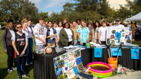 Anna Krift, director of Citizenship Project, and class stand around saving oceans project at Citizenship Celebration.