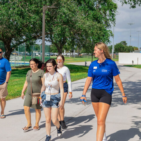 Prospective students get a tour of Lynn University from a student admission ambassador.
