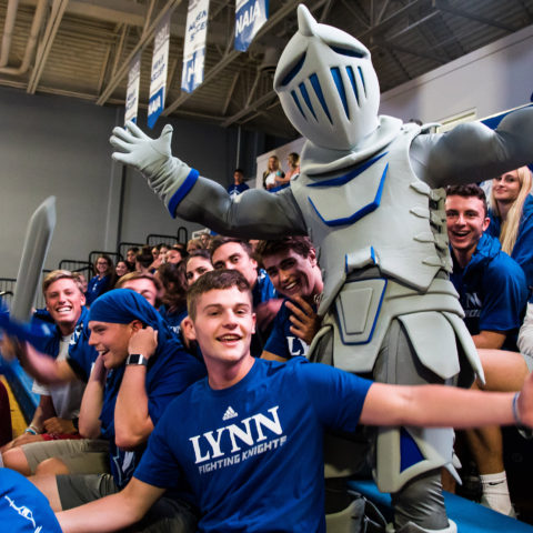 Students cheer with Lance at a Fighting Knights game.
