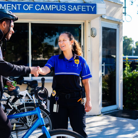 Campus Safety officer talks with student.