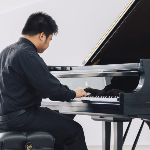 Student gets advanced training to earn his piano master.