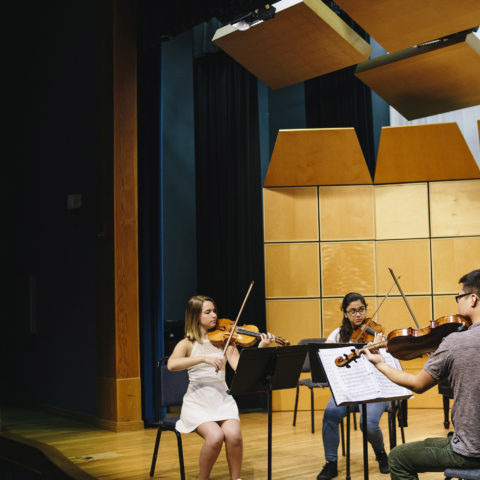 Students playing in the conservatory to earn their master’s in music.