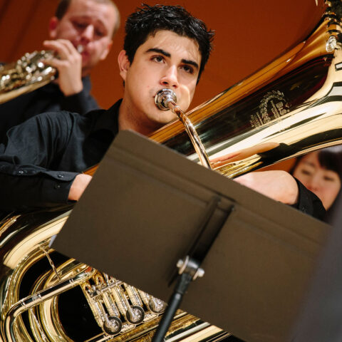A student plays in the brass department.