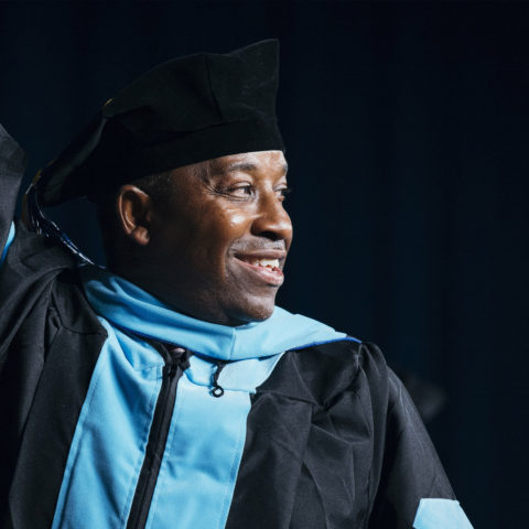 Student waves at the commencement ceremony