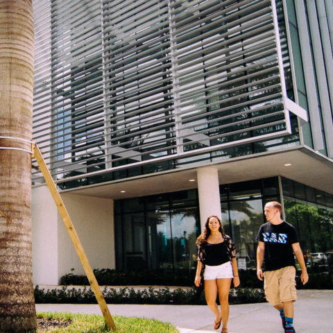 Two students walking outside the Mohammed Indimi International Business Center.