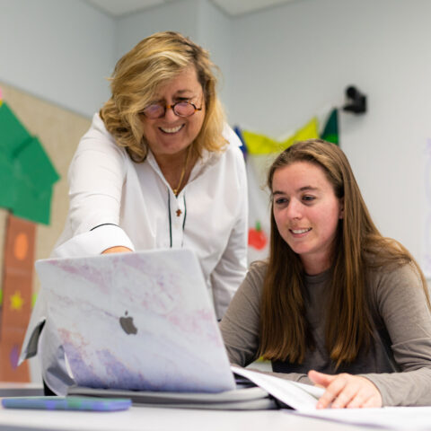 Professor Jennifer Lesh and student collaborating in a masters of education class.