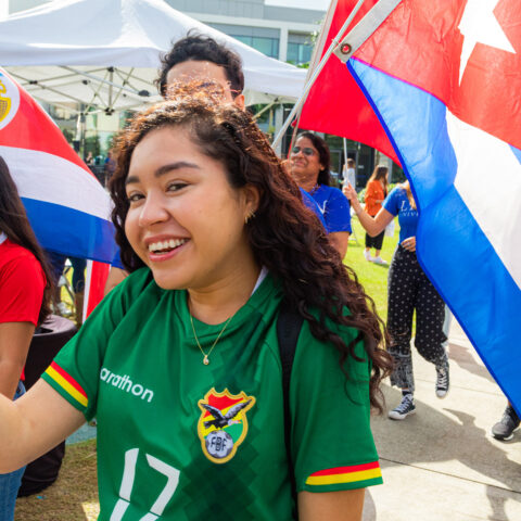 Students carry flags and walk through campus at Celebration of Nations event.