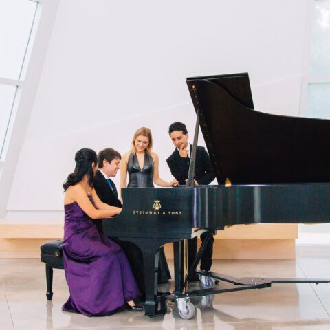 Students play piano in the Snyder Sanctuary.
