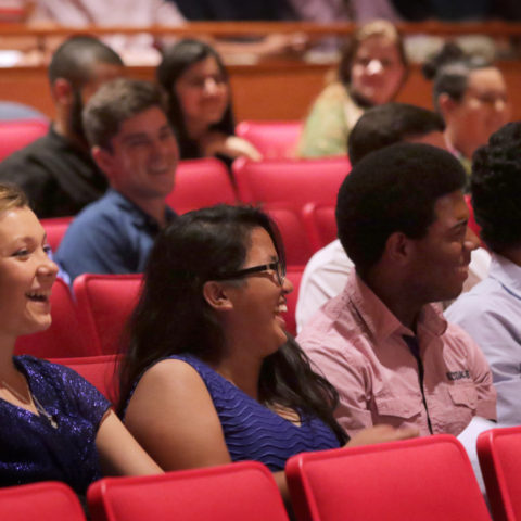 Students sit in the Wold Performing Arts Center.