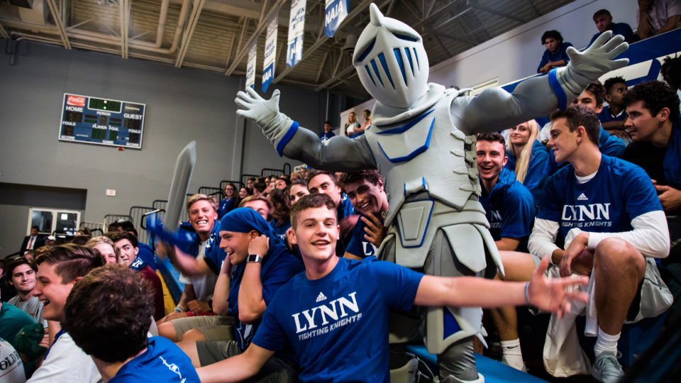 Students cheer with Lance at a Fighting Knights game.