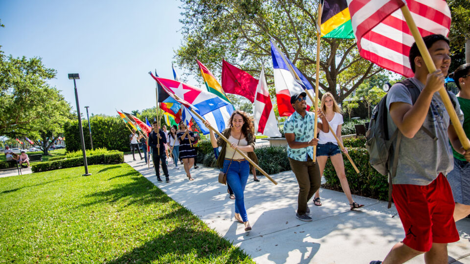 Students walking to park with flags