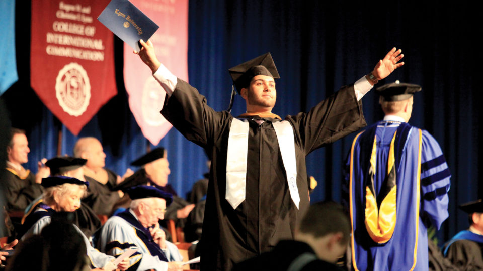 Student walks across the stage at Commencement