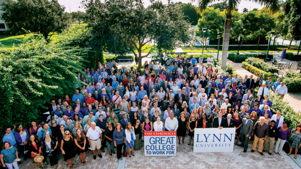 Lynn's faculty and staff pose with Great Colleges to Work for Sign in Perper Plaza